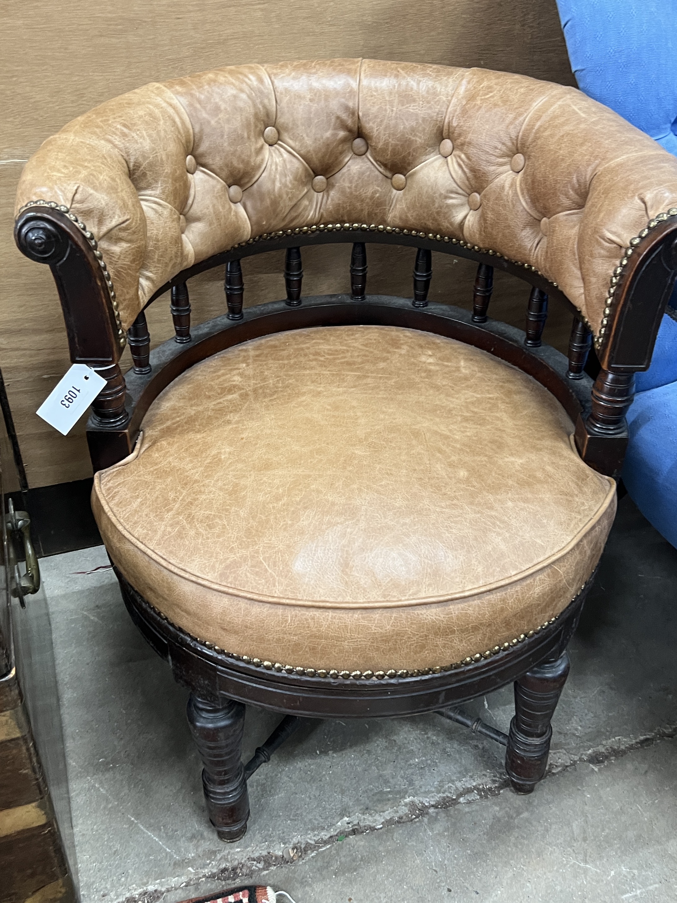 A late Victorian mahogany buttoned brown leather swivel desk chair, width 64cm, depth 56cm, height 74cm, together with a Victorian spoonback open armchair